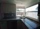 Bright kitchen with granite countertops, stainless steel sink, and tiled backsplash at 844 67Th S St, South Pasadena, FL 33707