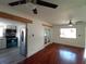 Open living space with kitchen, hardwood floors, and two ceiling fans at 844 67Th S St, South Pasadena, FL 33707