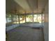 Enclosed patio with tile flooring, a ceiling fan, and window walls providing natural light at 844 67Th S St, South Pasadena, FL 33707