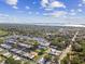 Expansive aerial view of a community with waterfront access, mature trees, and well-maintained landscaping at 854 Sky Loch N Dr, Dunedin, FL 34698