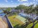 Aerial view showcasing the shuffleboard courts, manicured lawns, and waterfront access at 854 Sky Loch N Dr, Dunedin, FL 34698