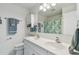 Bathroom with double sink vanity, framed mirror, and coordinated fixtures and decor at 854 Sky Loch N Dr, Dunedin, FL 34698