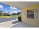 View from the carport, showcasing the lush surroundings and neighborhood street at 854 Sky Loch N Dr, Dunedin, FL 34698