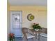 Inviting front entryway with charming decorations, potted plants, and a cozy atmosphere at 854 Sky Loch N Dr, Dunedin, FL 34698