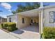 Charming home exterior with a covered carport and inviting entrance area at 854 Sky Loch N Dr, Dunedin, FL 34698