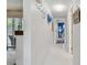 Hallway leading to a bedroom and a screened-in patio, with beach themed decor at 854 Sky Loch N Dr, Dunedin, FL 34698