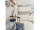 Cozy kitchen featuring white cabinets, drop-leaf table, and nautical-themed decor at 854 Sky Loch N Dr, Dunedin, FL 34698