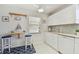 Well-lit kitchen with white cabinets, breakfast bar, and modern appliances at 854 Sky Loch N Dr, Dunedin, FL 34698