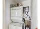 Efficient laundry area featuring stacked washer and dryer, maximizing space and convenience at 854 Sky Loch N Dr, Dunedin, FL 34698