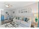 Cozy living room with comfortable seating, ceiling fan, and coastal-inspired decor at 854 Sky Loch N Dr, Dunedin, FL 34698