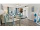 Comfortable living room with a round table, coastal accents, and sliding glass door to screened-in porch at 854 Sky Loch N Dr, Dunedin, FL 34698