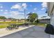 Community patio area with tables, barbecue, and water view at 854 Sky Loch N Dr, Dunedin, FL 34698