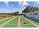 Community shuffleboard courts with clearly marked boundaries, seating, and lush surroundings at 854 Sky Loch N Dr, Dunedin, FL 34698