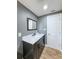 Bathroom featuring a vanity with marble countertop and framed mirror at 8648 78Th Pl, Seminole, FL 33777