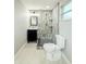 Modern bathroom featuring tile shower, black vanity, and neutral color palette at 8648 78Th Pl, Seminole, FL 33777