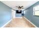 Open-concept living space with ceiling fan, tile floors, and a media center at 8648 78Th Pl, Seminole, FL 33777
