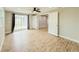 Bedroom with wood-look tile flooring, ceiling fan, access to patio and ensuite bathroom at 8648 78Th Pl, Seminole, FL 33777