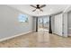 Light filled bedroom featuring wood-look tile flooring, fresh paint, ceiling fan, and sliding glass door at 8648 78Th Pl, Seminole, FL 33777