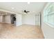 Bedroom with wood-look tile, neutral paint, ceiling fan, large window, and access to other areas at 8648 78Th Pl, Seminole, FL 33777
