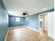 Spacious bedroom with wood-look flooring, blue walls, and natural light at 8648 78Th Pl, Seminole, FL 33777