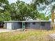Single story house with blue walls and a detached garage at 8648 78Th Pl, Seminole, FL 33777
