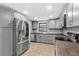 Bright kitchen features gray cabinets, butcher block counters, stainless steel appliances, and stylish subway tile backsplash at 8648 78Th Pl, Seminole, FL 33777