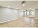 Bright living room with wood-look tile floors, neutral paint, updated lighting, and large windows at 8648 78Th Pl, Seminole, FL 33777