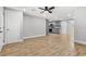 Open living room boasts wood-look tile flooring, fresh gray paint, and easy access to the kitchen at 8648 78Th Pl, Seminole, FL 33777