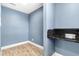 A blue room with wood-look floors and a granite countertop shelf at 8648 78Th Pl, Seminole, FL 33777