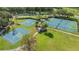 This aerial view shows the basketball and tennis courts within the community at 5754 Sweet William Ter, Land O Lakes, FL 34639