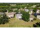 Aerial view of a home featuring a screened-in lanai and a spacious green lawn at 5754 Sweet William Ter, Land O Lakes, FL 34639