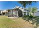 A view of the backyard featuring a screened-in patio attached to the house at 5754 Sweet William Ter, Land O Lakes, FL 34639