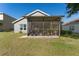 Backyard with a screened-in lanai with potted plants providing a comfortable outdoor retreat at 5754 Sweet William Ter, Land O Lakes, FL 34639