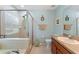Well-lit bathroom featuring a shower, bathtub, and a neutral color scheme at 5754 Sweet William Ter, Land O Lakes, FL 34639