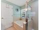 Bright bathroom featuring a bathtub, walk-in shower, and an ample storage at 5754 Sweet William Ter, Land O Lakes, FL 34639
