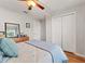 Comfortable bedroom featuring hardwood floors, ceiling fan, and a large closet at 5754 Sweet William Ter, Land O Lakes, FL 34639