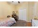 Cozy bedroom featuring hardwood floors, a window, and closet with doors at 5754 Sweet William Ter, Land O Lakes, FL 34639