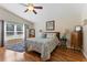 Bright bedroom with hardwood floors, ceiling fan, and large window with natural light at 5754 Sweet William Ter, Land O Lakes, FL 34639