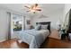 Charming bedroom featuring hardwood floors, ceiling fan, and natural light at 5754 Sweet William Ter, Land O Lakes, FL 34639