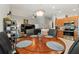 Open-concept dining area adjacent to kitchen featuring a hardwood table and contemporary furnishings at 5754 Sweet William Ter, Land O Lakes, FL 34639