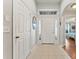Bright foyer featuring neutral tile floors, transom windows, and a view into adjacent living spaces at 5754 Sweet William Ter, Land O Lakes, FL 34639