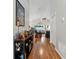 Hallway with hardwood floors, leading to the living area, decorated with tasteful accents and warm lighting at 5754 Sweet William Ter, Land O Lakes, FL 34639