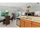 Open concept kitchen with breakfast bar that looks into the living room and adjacent dining area at 5754 Sweet William Ter, Land O Lakes, FL 34639