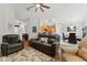Comfortable living room showcasing a plush sofa, chairs, and a floral area rug at 5754 Sweet William Ter, Land O Lakes, FL 34639