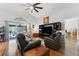 Inviting living room featuring vaulted ceilings, hardwood floors, and comfortable leather seating at 5754 Sweet William Ter, Land O Lakes, FL 34639