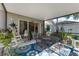 Enclosed back patio featuring a dining table, chairs, and view of the house at 5754 Sweet William Ter, Land O Lakes, FL 34639