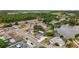 Aerial view of the home showing its location, the adjacent lake, and surrounding neighborhood at 1023 Springtime Dr, Holiday, FL 34691
