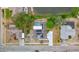 Overhead view of the home with solar panels, a pool, and proximity to a lakefront, complemented by a large driveway at 1023 Springtime Dr, Holiday, FL 34691