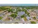 Stunning aerial view of the property with a beautiful pond and mature trees in a serene neighborhood setting at 1023 Springtime Dr, Holiday, FL 34691