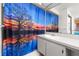 Bathroom with a vanity sink and a vibrant tree patterned shower curtain at 1023 Springtime Dr, Holiday, FL 34691